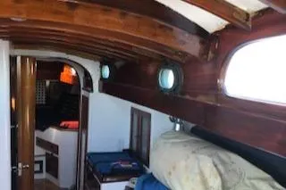Slide: The Image of Interior of 1958 Custom Larson 40 boat with wooden beams and portholes. - 12