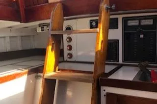 Slide: The Image of Interior of 1958 Custom Larson 40 boat with wooden ladder and control panels. - 14