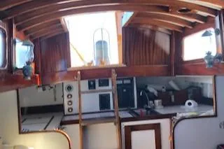Slide: The Image of Interior of a 1958 Custom Larson 40 boat with wooden beams and nautical decor. - 18