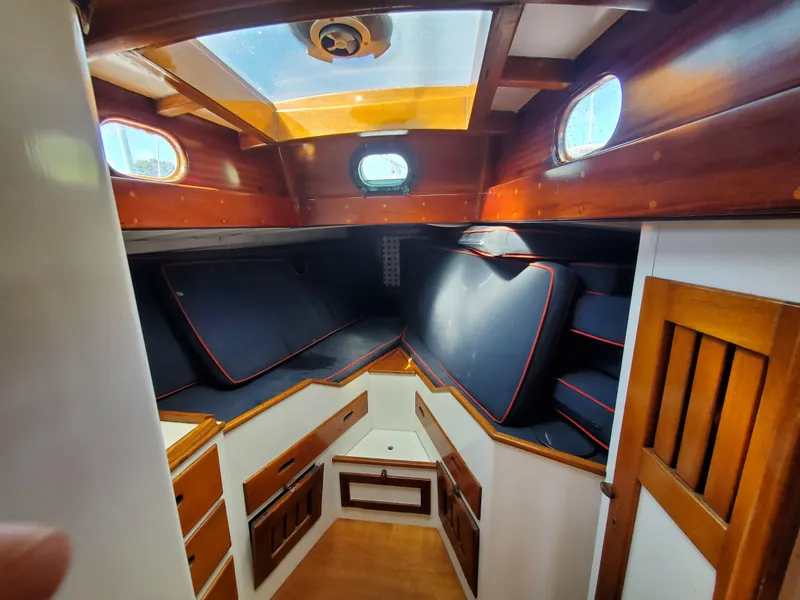 Slide: The Image of Cozy cabin interior of 1958 Custom Larson 40 boat with wooden finishes and skylight. - 4