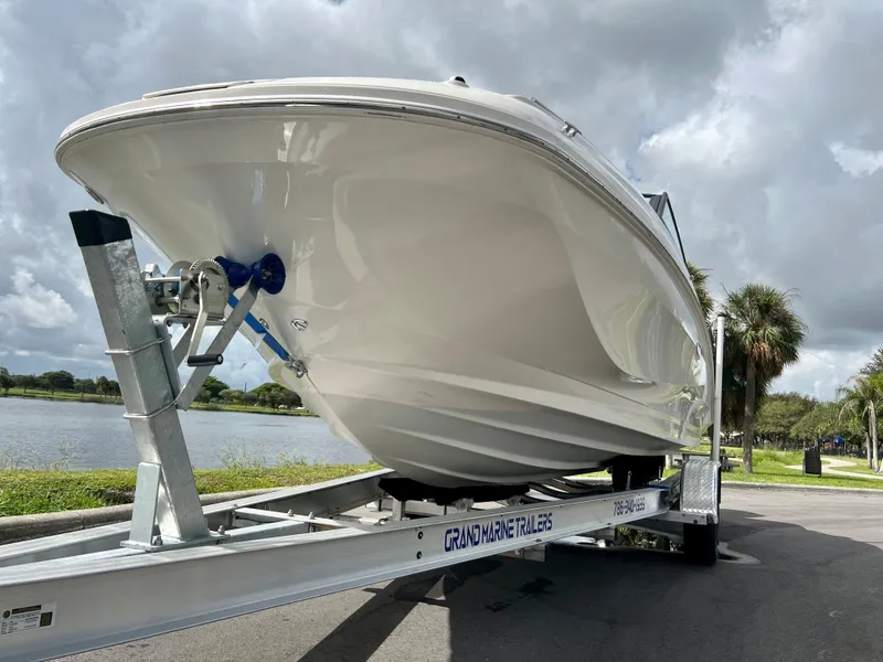 Slide: The Image of 2020 Sea Ray SDX 250 boat on trailer by a lake. - 12