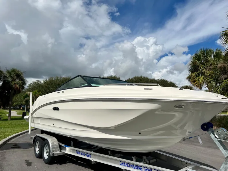 Slide: The Image of 2020 Sea Ray SDX 250 boat on a trailer under a partly cloudy sky. - 14