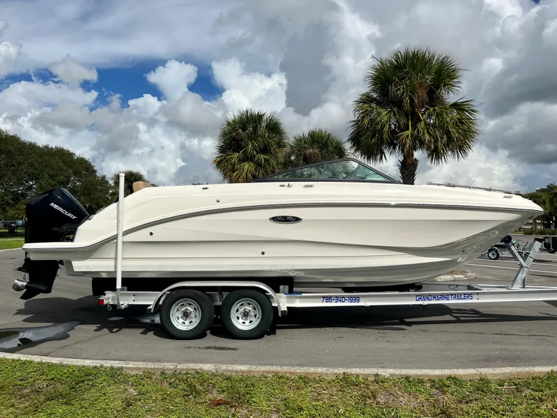 Slide: The Image of 2020 Sea Ray SDX 250 boat on a trailer with palm trees in the background. - 15