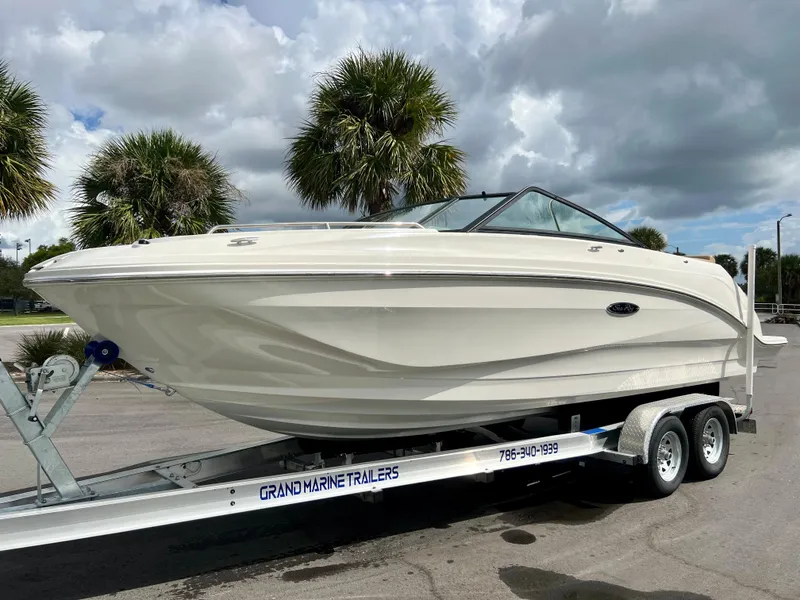 Slide: The Image of 2020 Sea Ray SDX 250 boat on a trailer with palm trees in the background. - 16