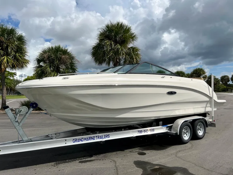 Slide: The Image of 2020 Sea Ray SDX 250 boat on trailer with palm trees in background. - 20