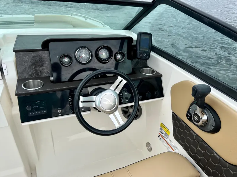 Slide: The Image of Cockpit of 2020 Sea Ray SDX 250 boat with steering wheel and control panel. - 26