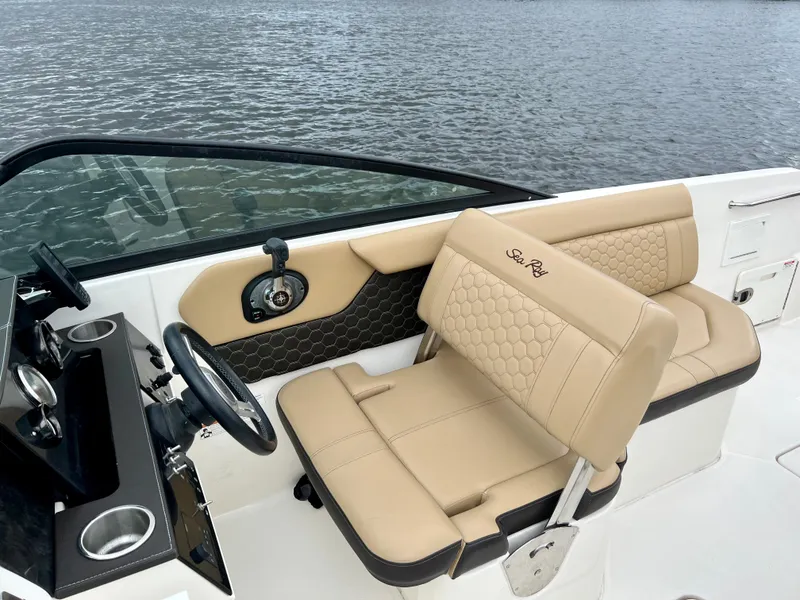 Slide: The Image of 2020 Sea Ray SDX 250 boat interior with tan seating and steering wheel. - 27