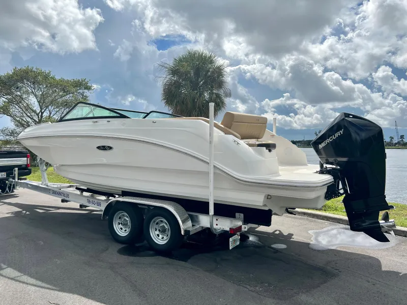 Slide: The Image of 2020 Sea Ray SDX 250 boat on a trailer by a lake under a cloudy sky. - 9