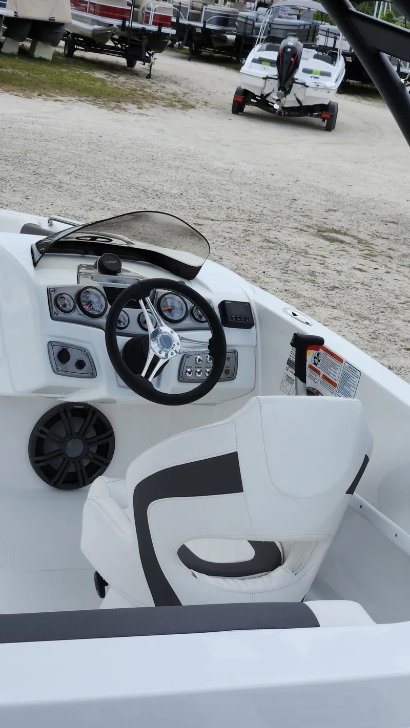 Slide: The Image of 2023 Tahoe 1950 boat interior with steering wheel and dashboard controls. - 3