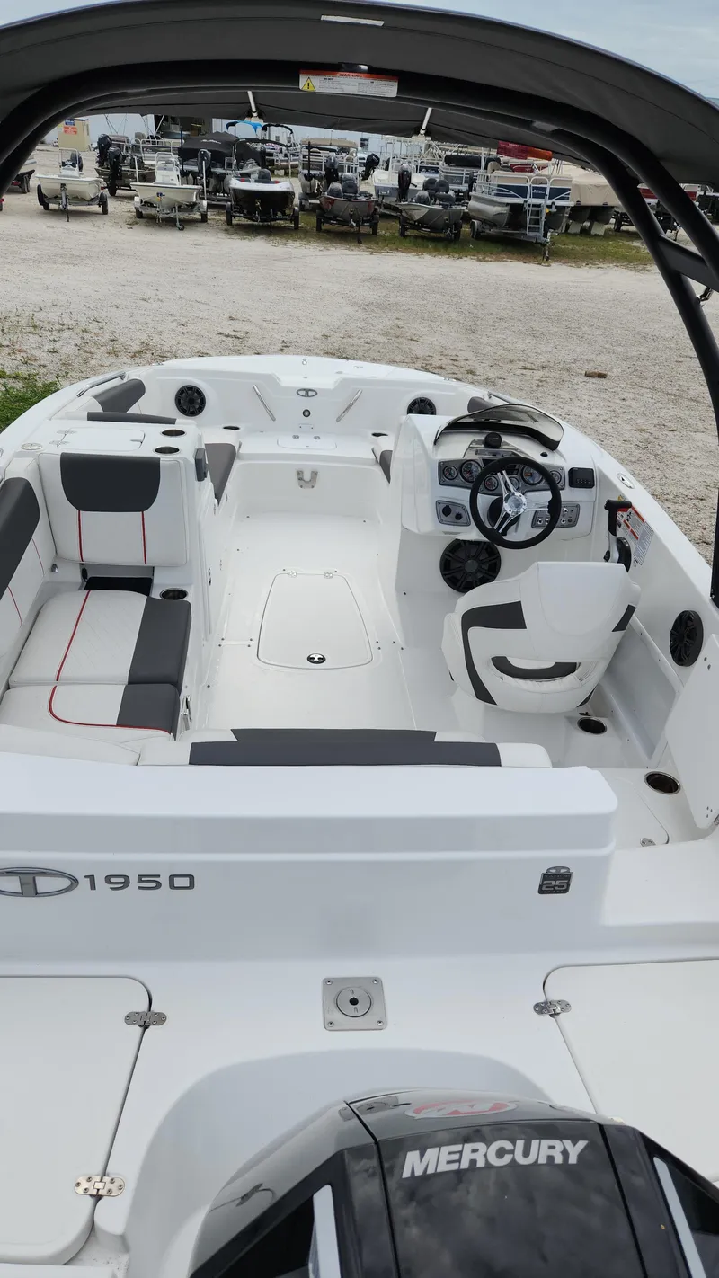 Slide: The Image of 2023 Tahoe 1950 boat interior with Mercury engine, featuring sleek seating and modern controls. - 4