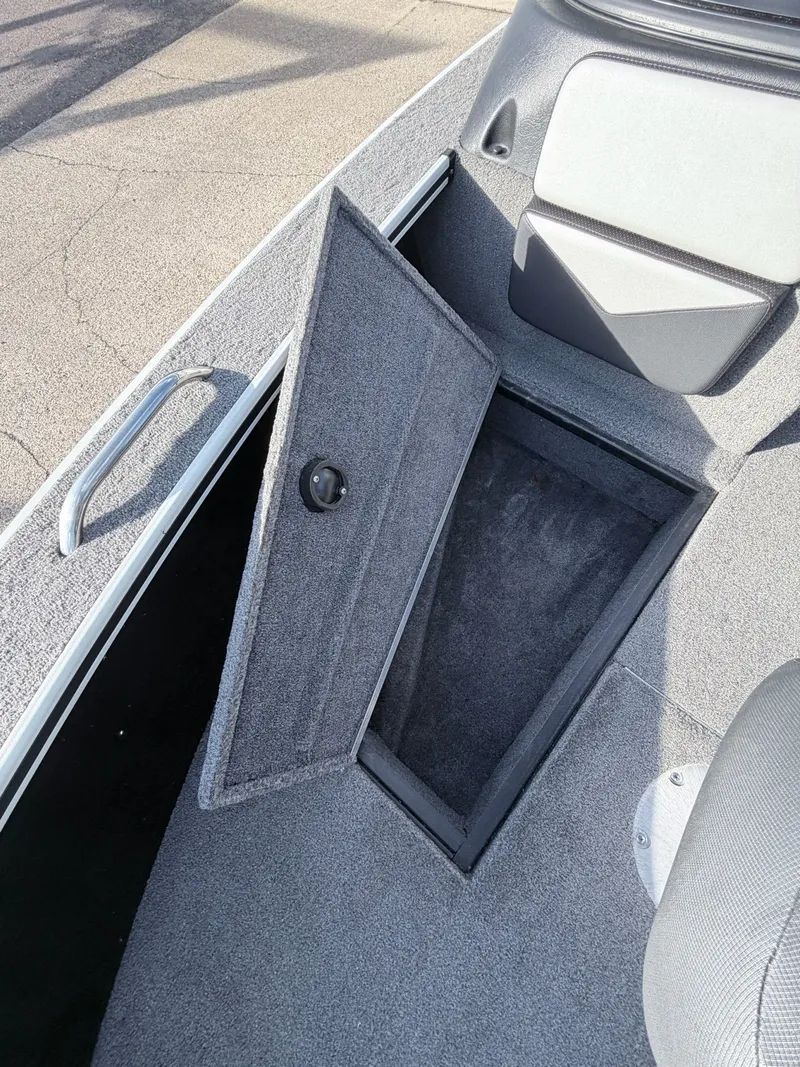 Slide: The Image of 2022 Alumacraft Edge 175 Sport boat with open storage compartment. - 32