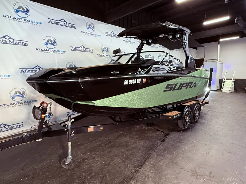 Slide: The Image of 2023 Supra SA 550 boat displayed in a showroom. - 12