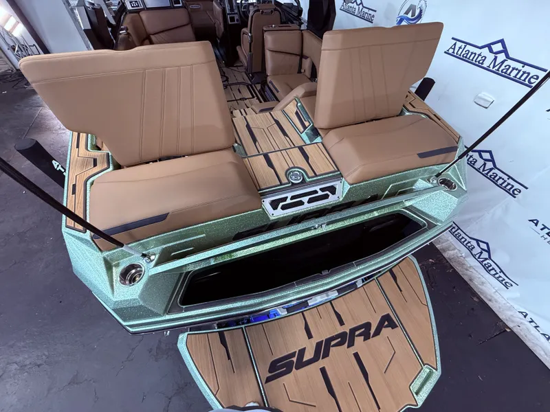 Slide: The Image of Interior of a 2023 Supra SA 550 boat with brown seats. - 14