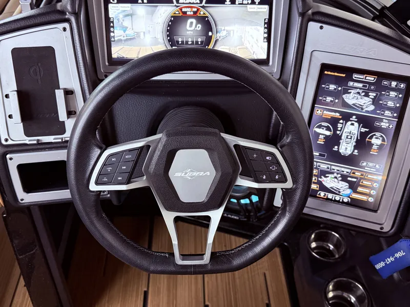 Slide: The Image of Interior of 2023 Supra SA 550 with modern steering wheel and touchscreen. - 26