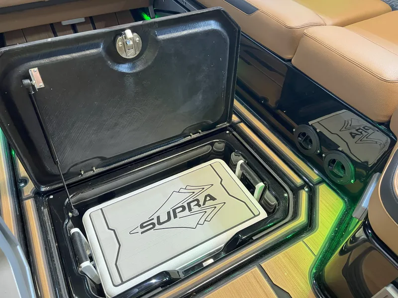 Slide: The Image of 2023 Supra SA 550 boat with open storage compartment. - 34