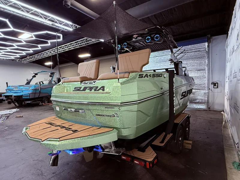 Slide: The Image of 2023 Supra SA 550 boat displayed in a garage. - 7
