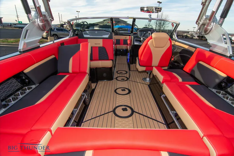 Slide: The Image of 2021 MasterCraft X24 boat interior with red and beige seating, spacious layout. - 14