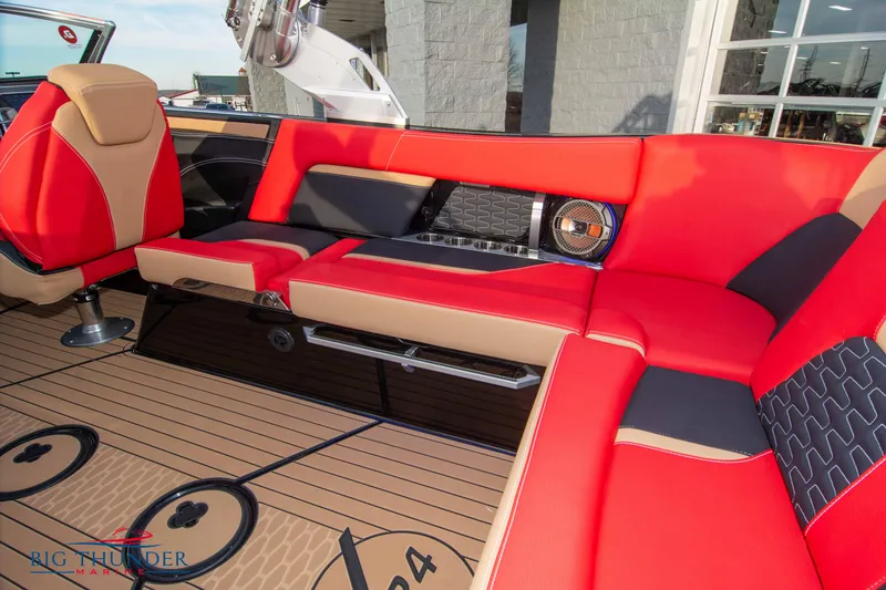 Slide: The Image of 2021 MasterCraft X24 boat interior with red and black seating and teak flooring. - 15