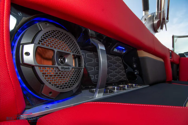 Slide: The Image of 2021 MasterCraft X24 boat interior with premium audio system and red upholstery. - 17