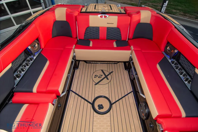 Slide: The Image of 2021 MasterCraft X24 boat interior with red and beige seating. - 18