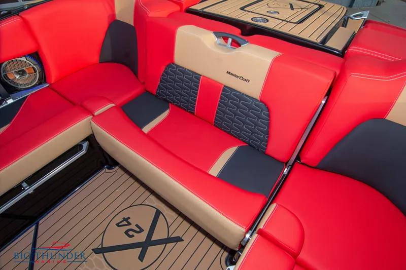 Slide: The Image of 2021 MasterCraft X24 boat interior with red and tan seating. - 19
