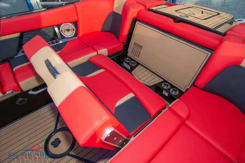 Slide: The Image of 2021 MasterCraft X24 boat interior with red and beige seating and premium audio system. - 20