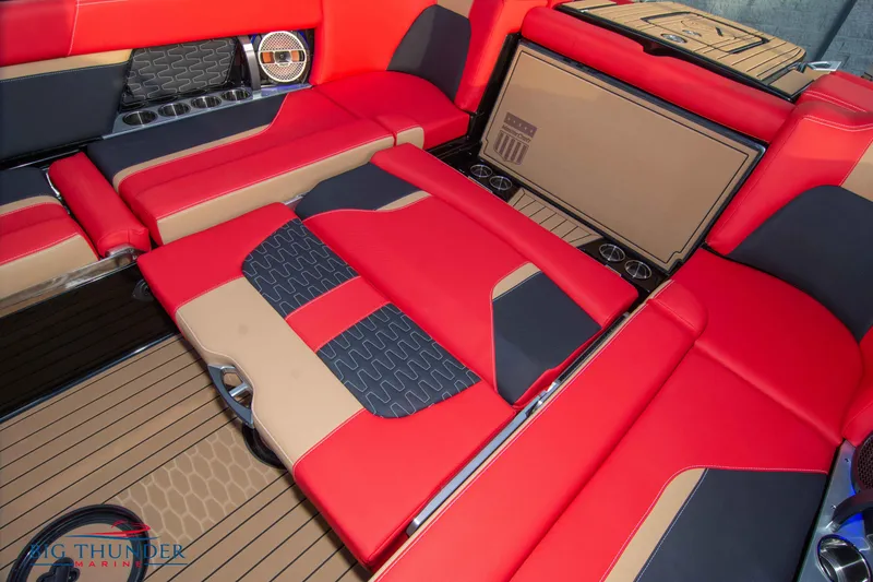 Slide: The Image of 2021 MasterCraft X24 boat interior with red and black seating. - 21