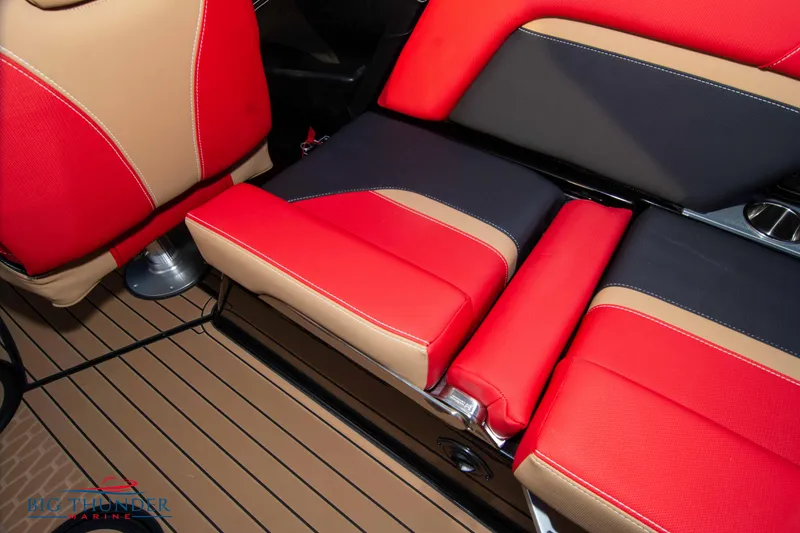 Slide: The Image of 2021 MasterCraft X24 boat interior with red, black, and beige seating. - 32