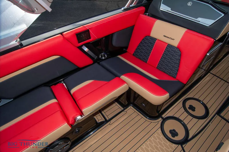 Slide: The Image of 2021 MasterCraft X24 boat interior with red and black seating. - 34