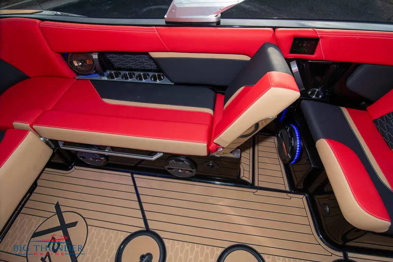 Slide: The Image of 2021 MasterCraft X24 boat interior with red and beige seating, premium flooring, and modern design. - 35