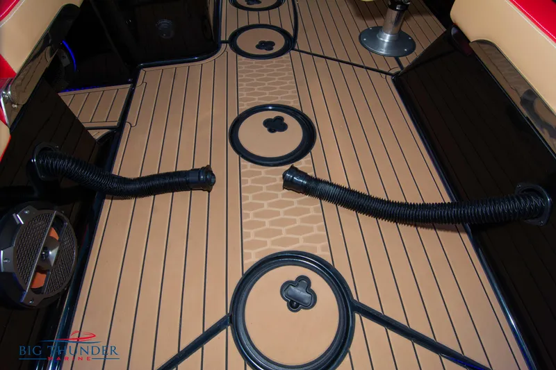 Slide: The Image of 2021 MasterCraft X24 boat interior with teak flooring and black fittings. - 38
