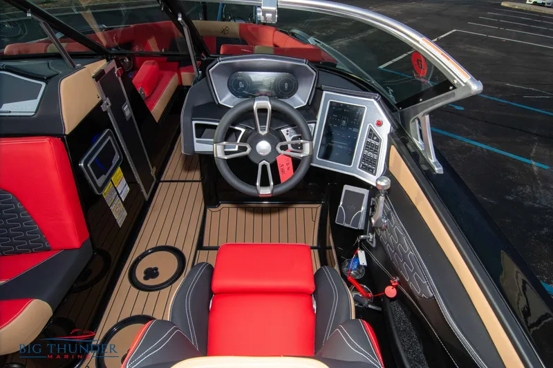 Slide: The Image of 2021 MasterCraft X24 boat cockpit with modern controls and red seating. - 39
