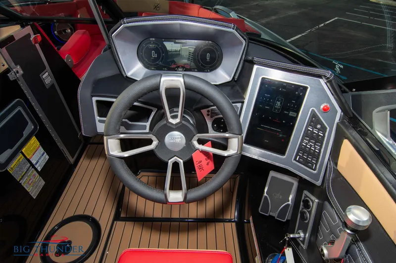 Slide: The Image of 2021 MasterCraft X24 boat dashboard with steering wheel and digital controls. - 40