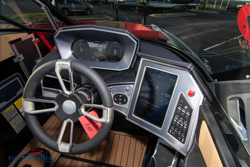 Slide: The Image of 2021 MasterCraft X24 boat dashboard with steering wheel and touchscreen controls. - 41