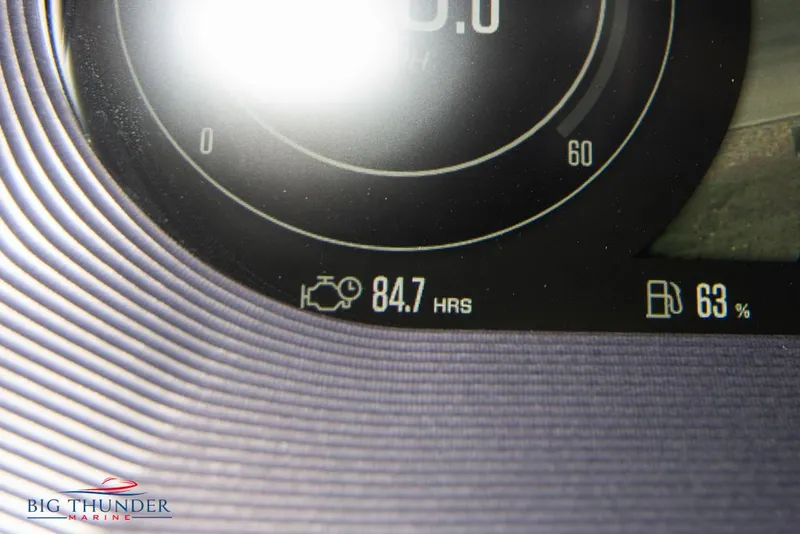 Slide: The Image of Close-up of 2021 MasterCraft X24 dashboard showing 84.7 engine hours and 63% fuel level. - 43