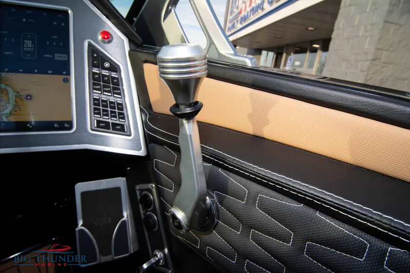 Slide: The Image of 2021 MasterCraft X24 boat interior with control lever and touchscreen display. - 46