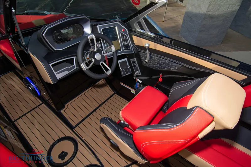 Slide: The Image of 2021 MasterCraft X24 boat cockpit with modern controls and red-black seating. - 48