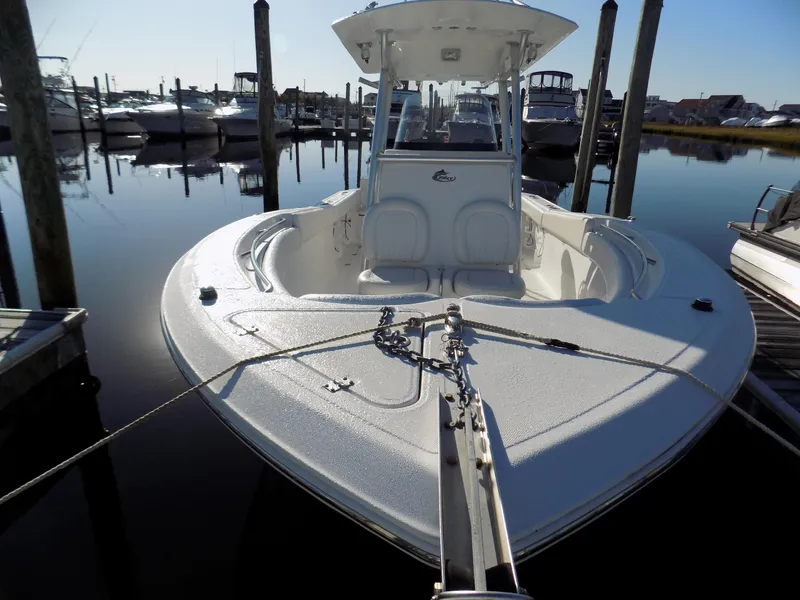 Slide: The Image of 2012 Sea Fox 256 Commander boat docked in a marina, calm water reflections. - 3