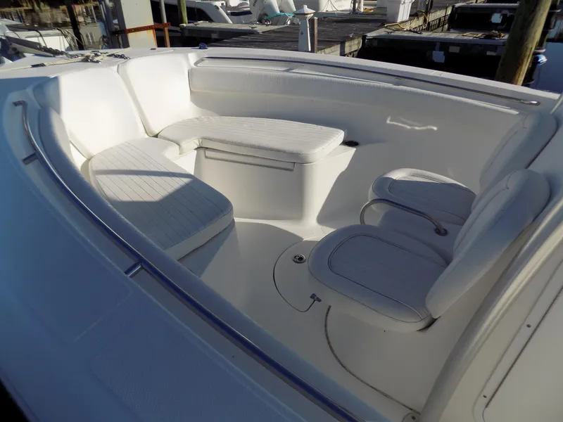 Slide: The Image of 2012 Sea Fox 256 Commander boat interior with white seating and storage compartments. - 4