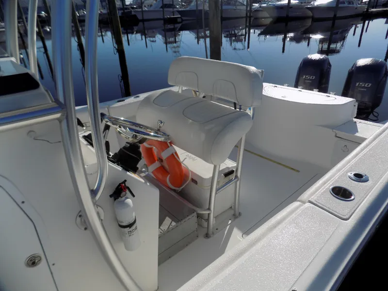 Slide: The Image of 2012 Sea Fox 256 Commander boat interior with seating, life jackets, and twin outboard motors. - 5