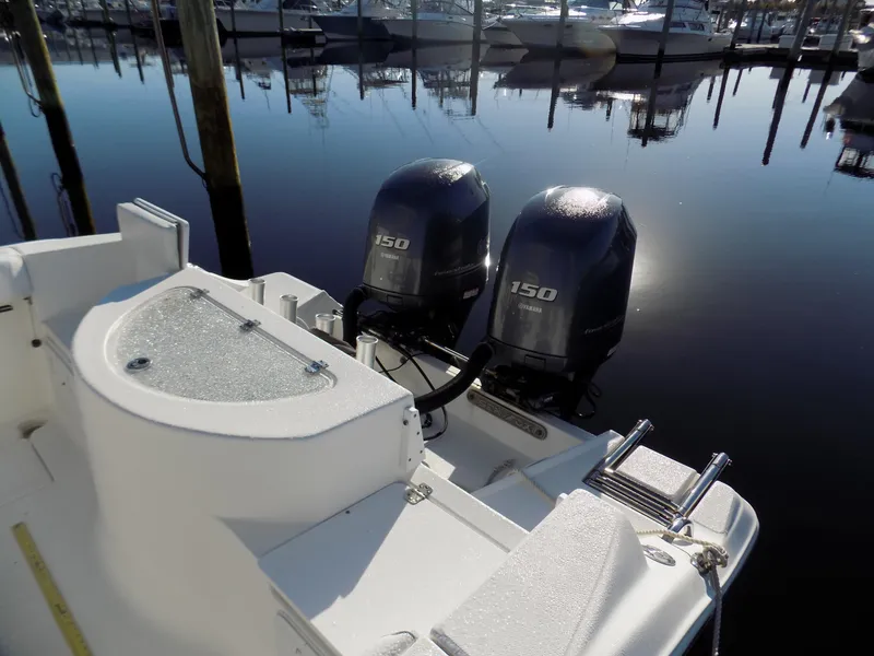 Slide: The Image of 2012 Sea Fox 256 Commander with twin 150 horsepower engines docked at marina. - 7