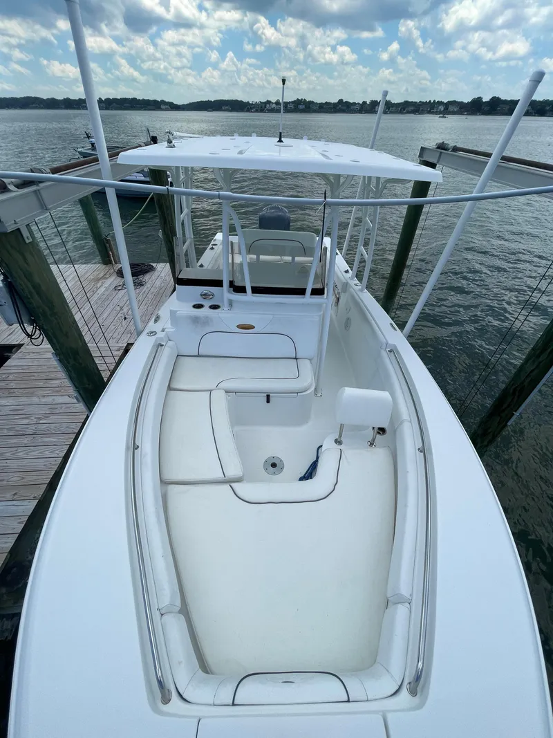 Slide: The Image of 2015 Sea Hunt Edge 24 boat docked at a marina. - 16
