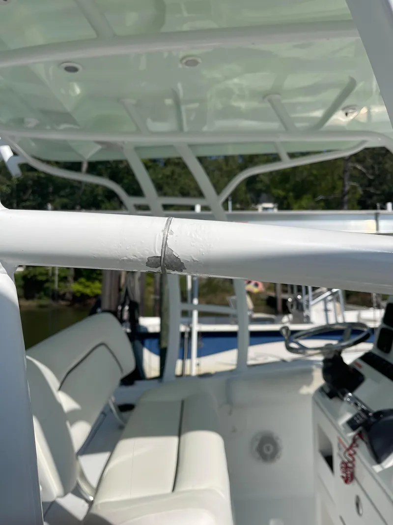 Slide: The Image of 2015 Sea Hunt Edge 24 boat interior with visible wear on the railing. - 17