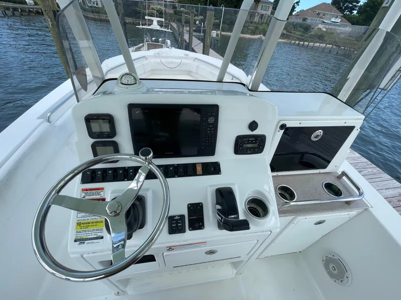 Slide: The Image of 2015 Sea Hunt Edge 24 boat console with steering wheel and navigation controls. - 20