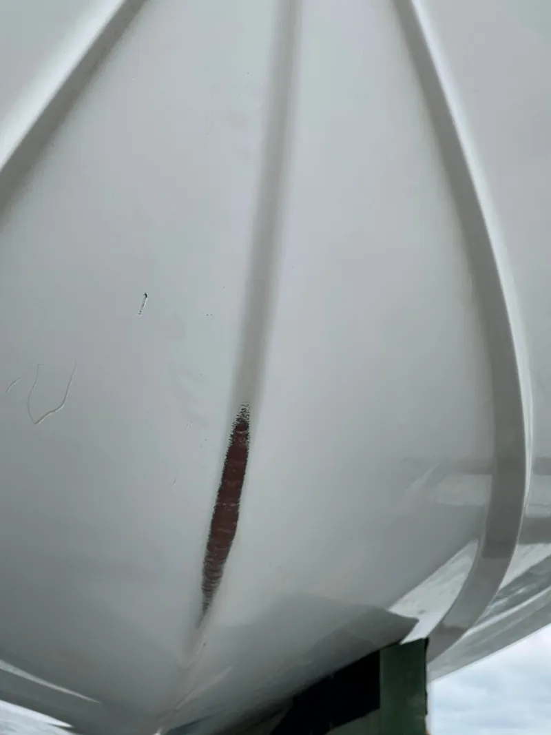 Slide: The Image of Close-up of 2015 Sea Hunt Edge 24 boat hull with visible damage. - 7