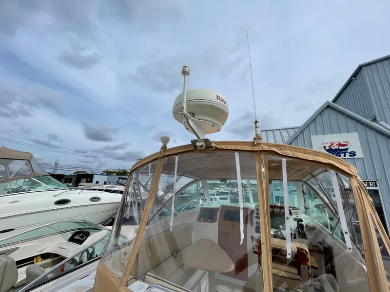 Slide: The Image of 2004 Hunt Yachts Surfhunter 29 cabin interior with kitchenette and seating area. - 11