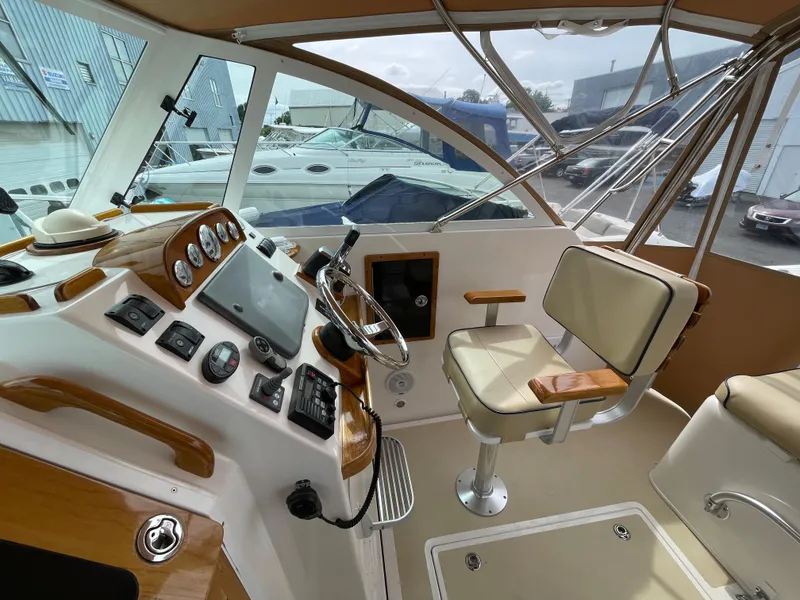 Slide: The Image of 2004 Hunt Yachts Surfhunter 29 helm with navigation instruments and wooden accents. - 3