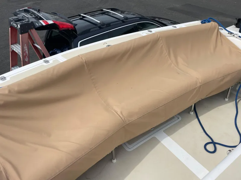 Slide: The Image of 2004 Hunt Yachts Surfhunter 29 interior with beige seating and a triangular table. - 6