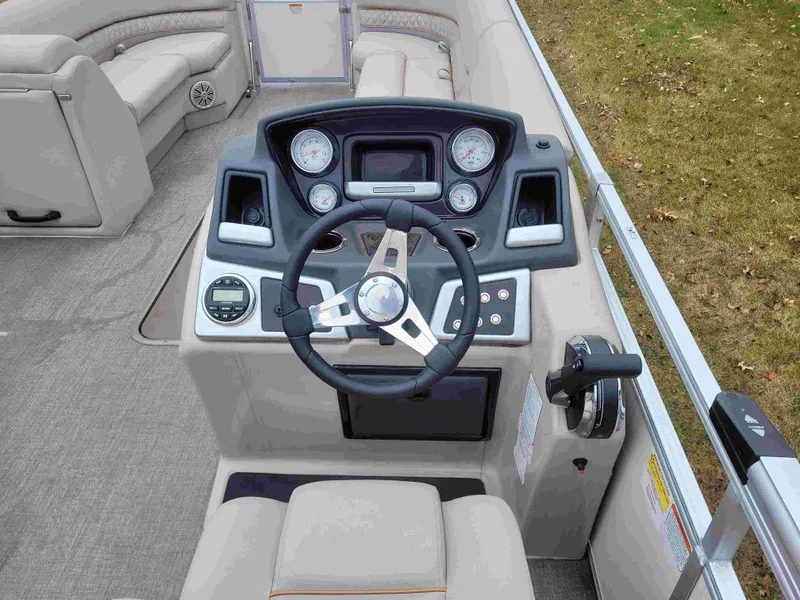 Slide: The Image of 2023 Ranger Reata 223C boat dashboard with steering wheel and control panel. - 2