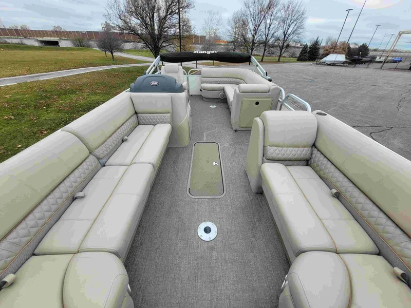 Slide: The Image of 2023 Ranger Reata 223C pontoon boat with spacious seating and modern design. - 4